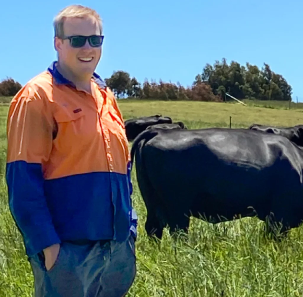 Jayden Limbrick, Training Farm Operations Manager at TasTAFE’s Freer Farm Training Facility overlooking the Angus herd.